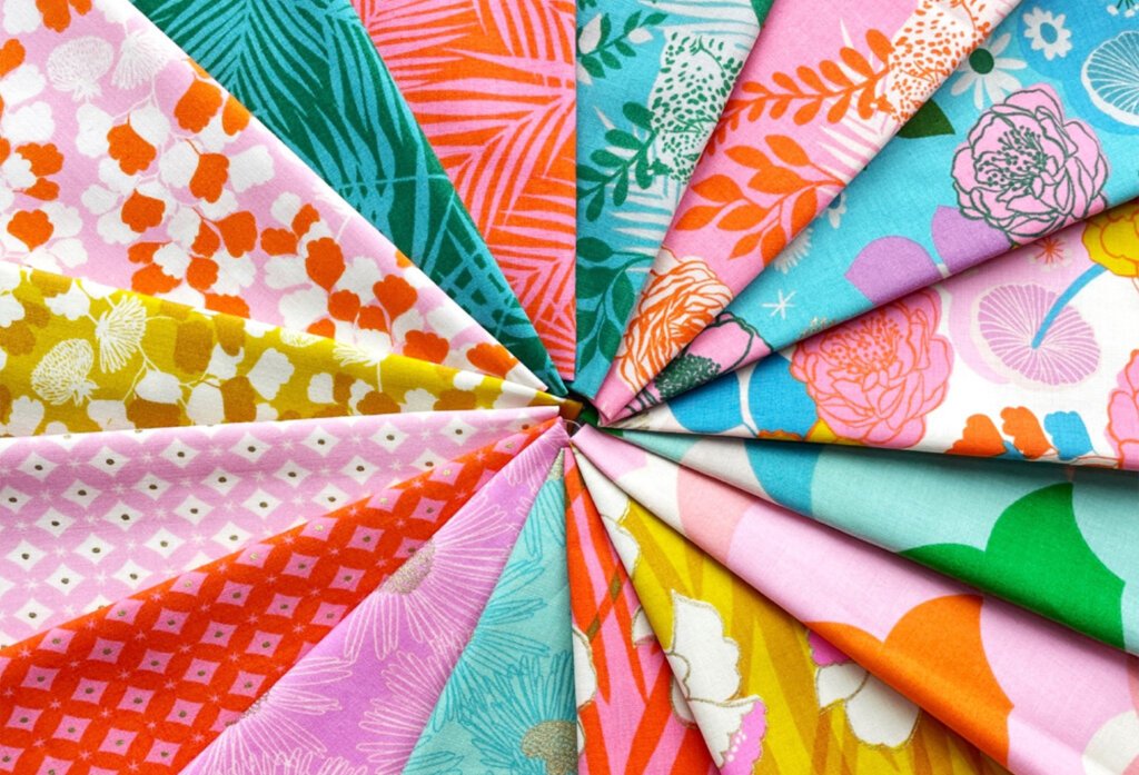 Colorful printed fabric swatches arranged in a fan.